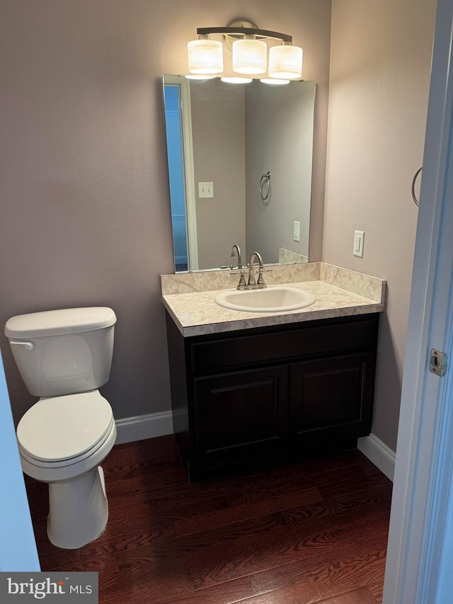 961 Rue Madora, Bear, DE 19701 - bathroom featuring toilet, baseboards, vanity, and wood finished floors