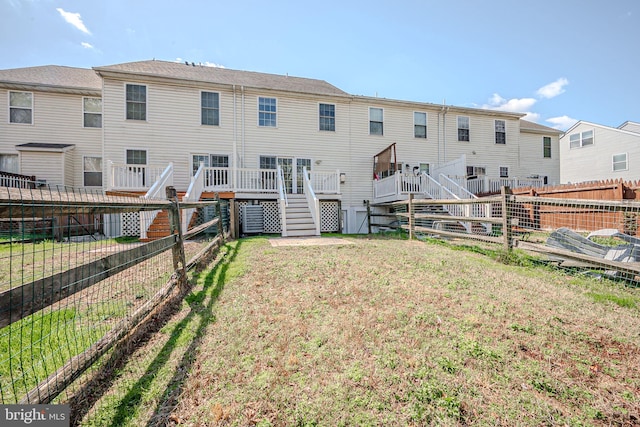 961 Rue Madora, Bear, DE 19701 - rear view of property with a fenced backyard, a deck, stairway, and a lawn