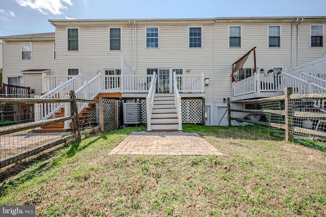 961 Rue Madora, Bear, DE 19701 - rear view of house with a yard, fence, stairway, and a wooden deck