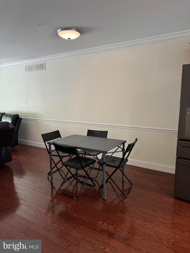 961 Rue Madora, Bear, DE 19701 - dining space featuring ornamental molding, baseboards, visible vents, and dark wood-style floors