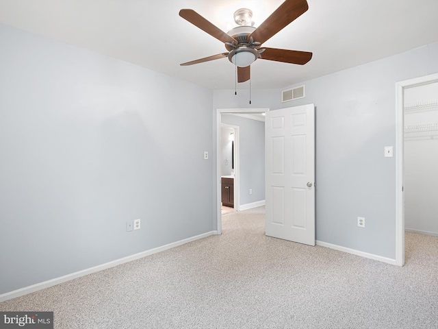 998 Glackens Ln, Wilmington, DE 19808 - unfurnished bedroom with light carpet, a walk in closet, a closet, and baseboards