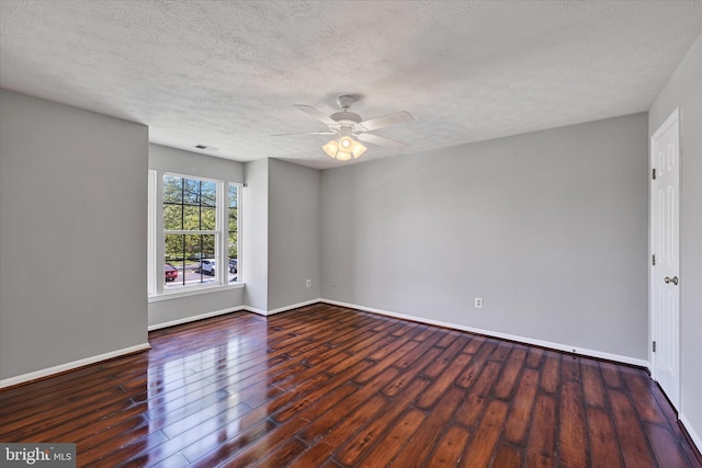unfurnished room with visible vents, wood finished floors, baseboards, ceiling fan, and a textured ceiling