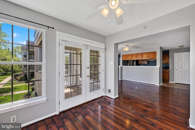 doorway with dark wood finished floors, french doors, a ceiling fan, baseboards, and visible vents