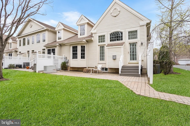 back of property with fence, entry steps, cooling unit, and a yard