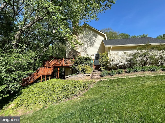 exterior space featuring a wooden deck, a yard, and stairway