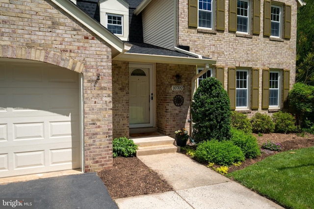 10702 Dundas Oak Ct, Burke, VA 22015 - doorway to property featuring brick siding, a shingled roof, and an attached garage