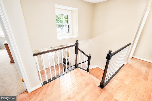 10702 Dundas Oak Ct, Burke, VA 22015 - staircase featuring baseboards and wood finished floors