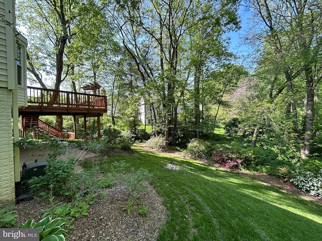 view of yard with a wooden deck and stairs