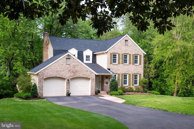 10702 Dundas Oak Ct, Burke, VA 22015 - view of front facade with aphalt driveway, brick siding, a garage, a front yard, and a chimney