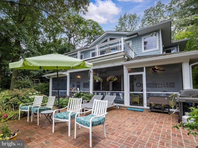 view of patio / terrace with a sunroom, a ceiling fan, a grill, and a balcony