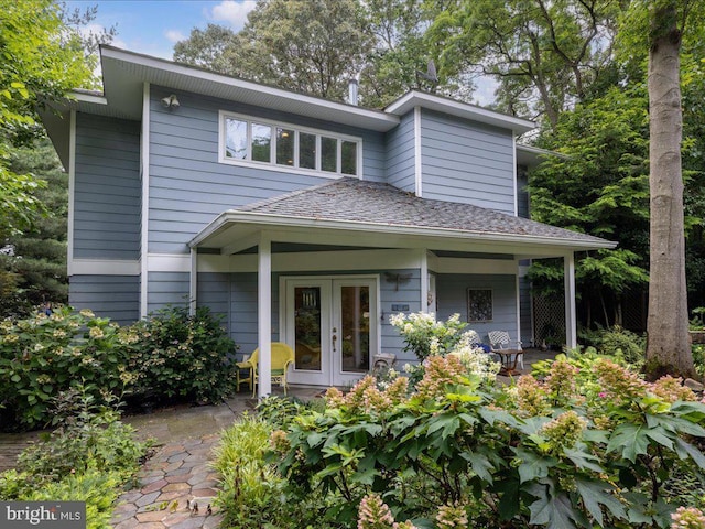 view of front of home featuring roof with shingles and french doors