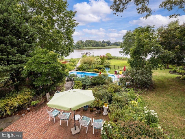 view of patio featuring an outdoor pool, fence, and a water view