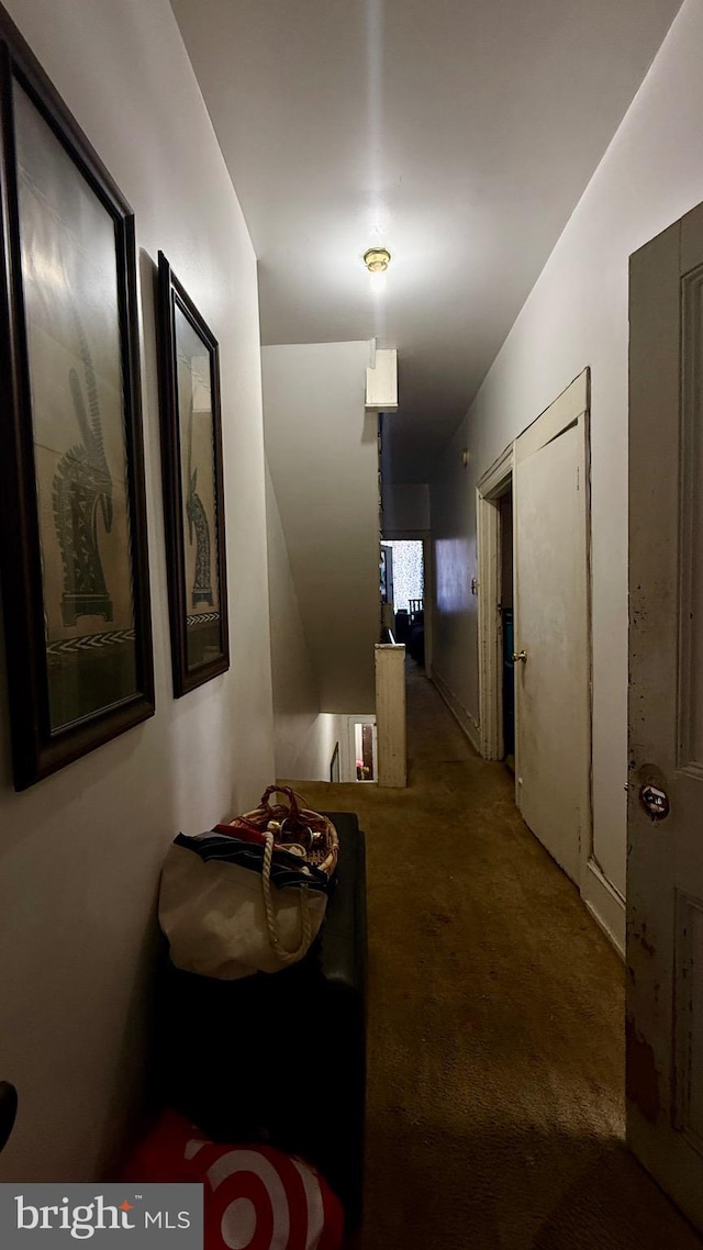 corridor with carpet flooring and an upstairs landing