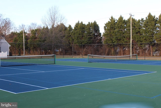view of tennis court with fence