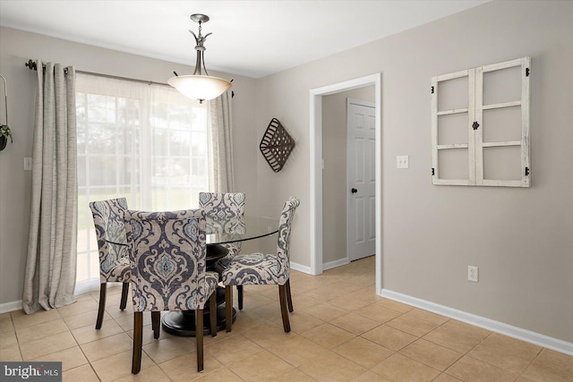 dining room featuring baseboards and light tile patterned floors