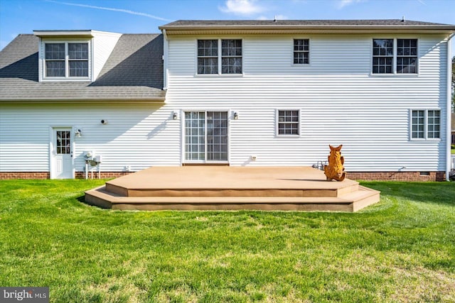 rear view of house featuring a lawn, crawl space, and a deck
