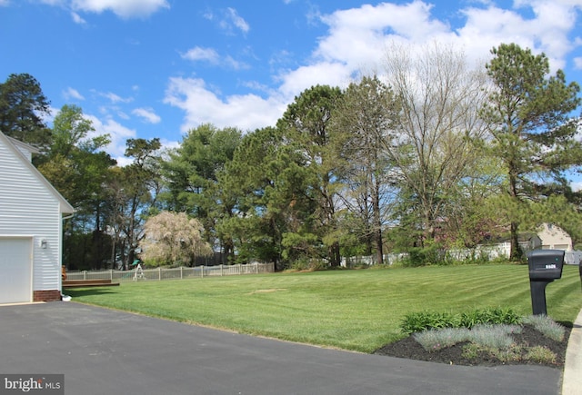 view of yard featuring a garage and fence