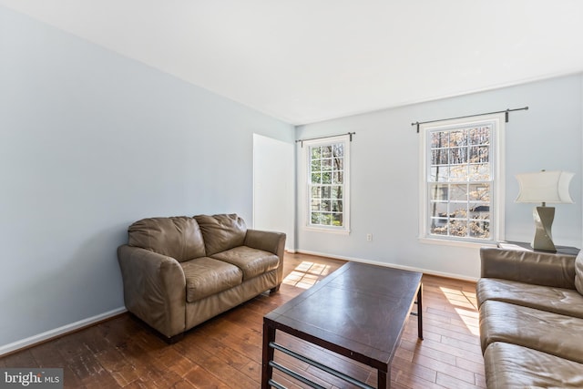 living room with hardwood / wood-style flooring and baseboards