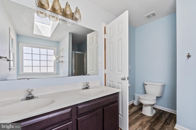 full bath featuring a sink, visible vents, a stall shower, and toilet