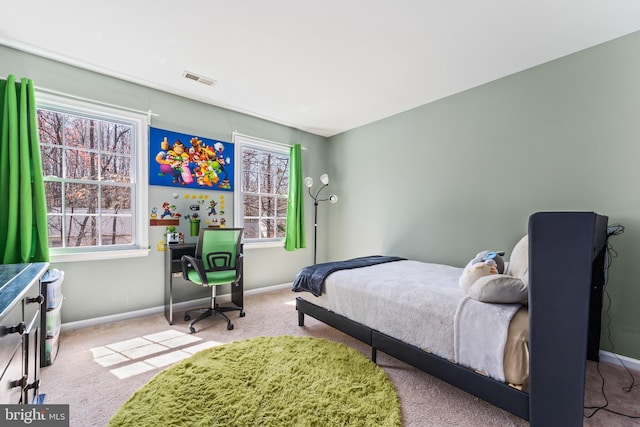 bedroom featuring baseboards, carpet flooring, and visible vents