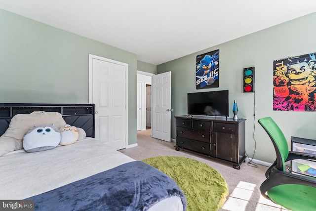 bedroom with light colored carpet and baseboards