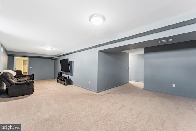 carpeted living area with baseboards and visible vents