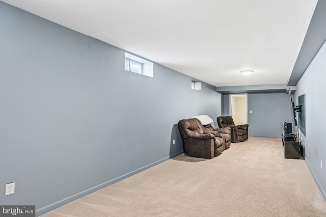 living area featuring baseboards and carpet