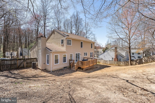 back of property featuring roof with shingles, a chimney, cooling unit, a deck, and fence