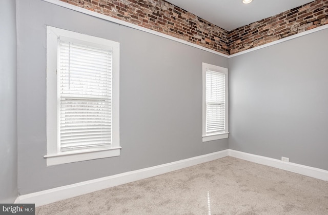 3524 Hickory Ave, Baltimore, MD 21211 - empty room featuring carpet, brick wall, and baseboards