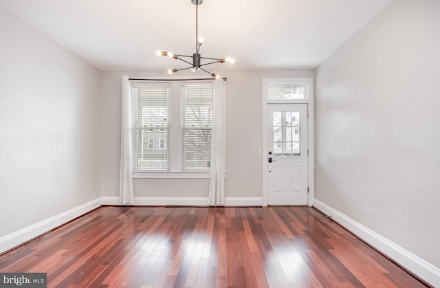 3524 Hickory Ave, Baltimore, MD 21211 - unfurnished dining area featuring baseboards, wood-type flooring, and an inviting chandelier