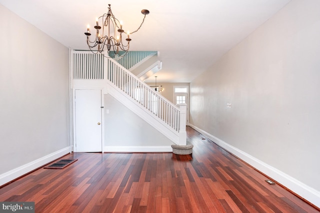 3524 Hickory Ave, Baltimore, MD 21211 - stairs with visible vents, a notable chandelier, baseboards, and wood finished floors