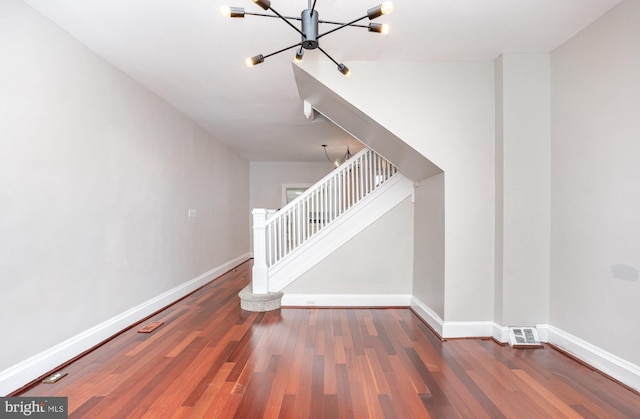 3524 Hickory Ave, Baltimore, MD 21211 - staircase featuring baseboards, a chandelier, and wood finished floors