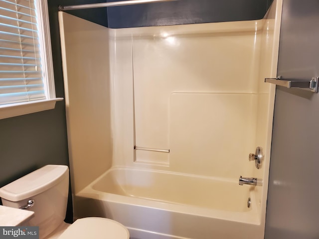 bathroom featuring bathtub / shower combination and toilet