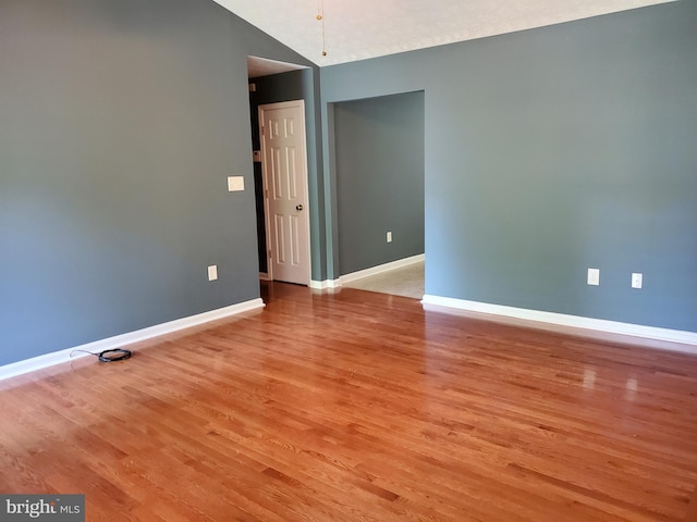 spare room featuring light wood finished floors and baseboards