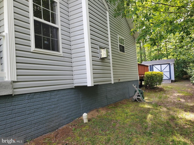 view of side of home with a storage unit and an outdoor structure