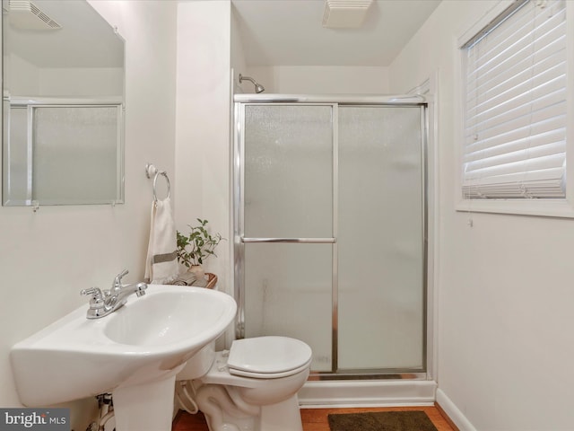 full bath featuring visible vents, toilet, a shower stall, and wood finished floors