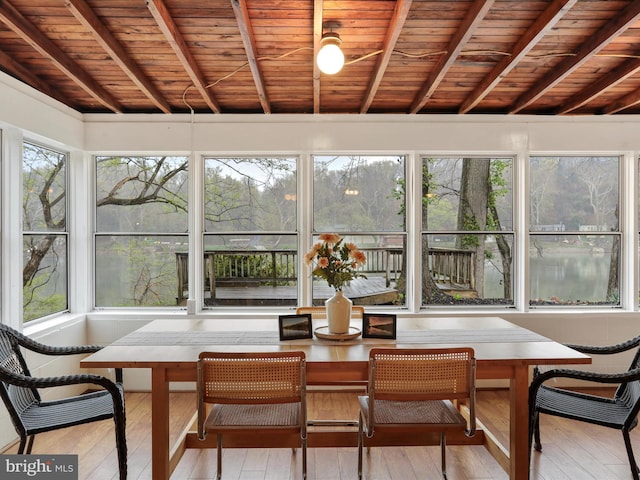 sunroom / solarium featuring wood ceiling, hardwood / wood-style floors, and lofted ceiling with beams