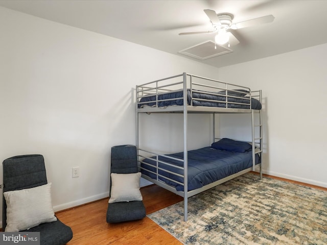 bedroom featuring baseboards, ceiling fan, and wood finished floors