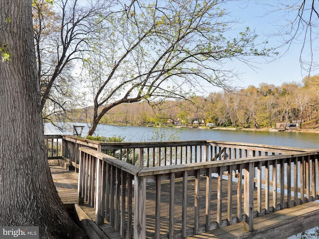 wooden terrace featuring a water view