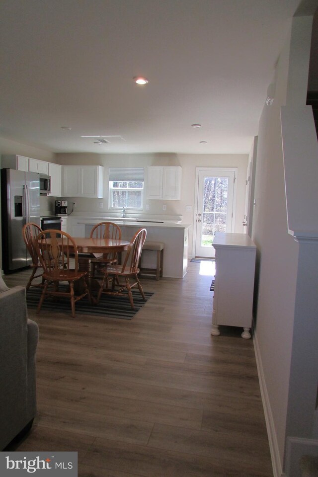 30155 Creekview Cir, Selbyville, DE 19975 - dining area featuring baseboards, wood finished floors, and recessed lighting