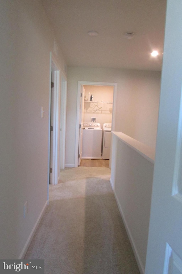 30155 Creekview Cir, Selbyville, DE 19975 - hall with light carpet, baseboards, and washer and dryer