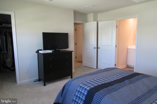 30155 Creekview Cir, Selbyville, DE 19975 - bedroom featuring a closet, ensuite bathroom, baseboards, light carpet, and a spacious closet