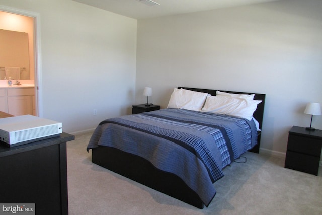 30155 Creekview Cir, Selbyville, DE 19975 - bedroom with a sink, ensuite bath, baseboards, and light colored carpet