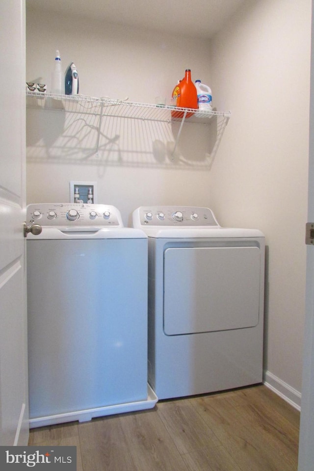 30155 Creekview Cir, Selbyville, DE 19975 - laundry area with baseboards, wood finished floors, washing machine and clothes dryer, and laundry area