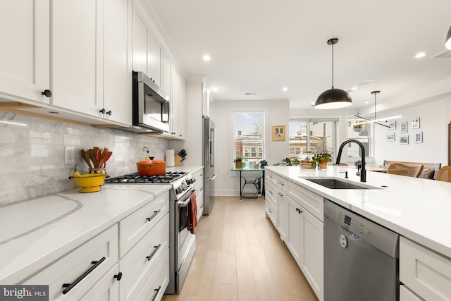 632 Rock Creek Church Rd NW Unit 2, Washington, DC 20010 - kitchen featuring appliances with stainless steel finishes, white cabinetry, tasteful backsplash, recessed lighting, and decorative light fixtures