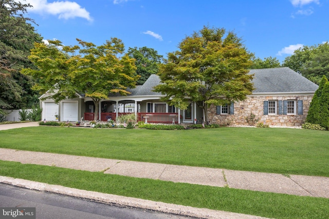 ranch-style home with a porch, roof with shingles, a front yard, stone siding, and concrete driveway