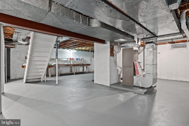 unfinished below grade area featuring heating unit