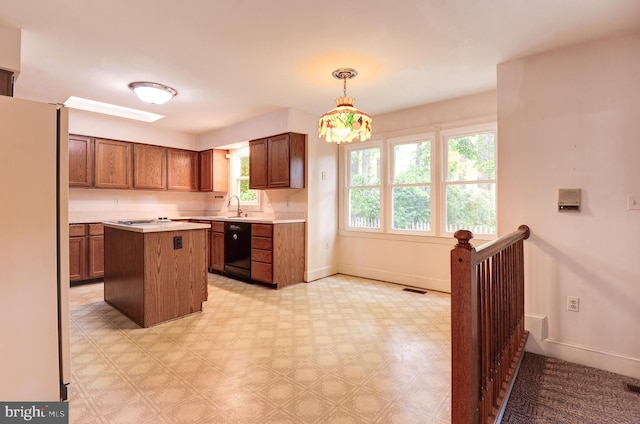 kitchen with freestanding refrigerator, dishwasher, baseboards, light countertops, and light flooring