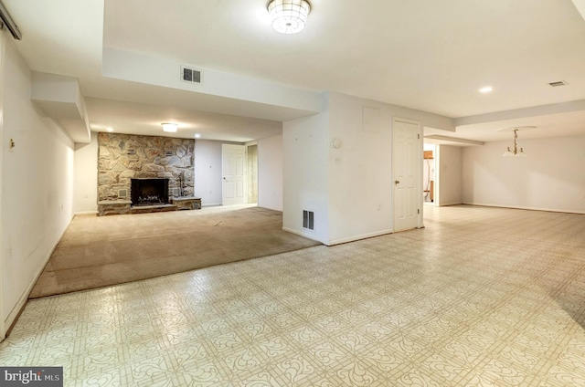 unfurnished living room featuring a stone fireplace, baseboards, and recessed lighting