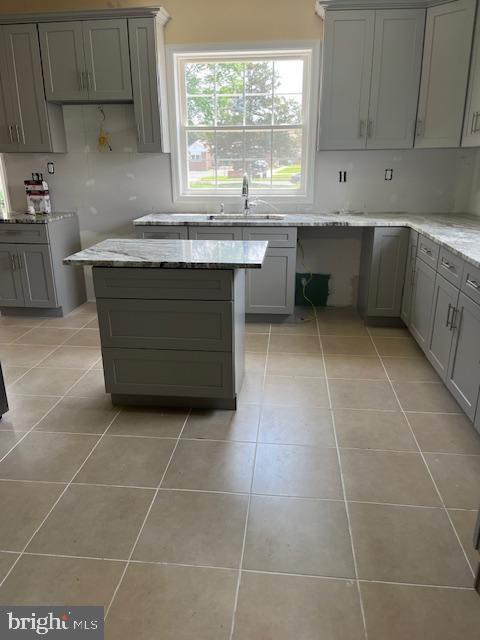628 W 2nd St, Florence, NJ 08518 - kitchen featuring gray cabinets and light tile patterned floors